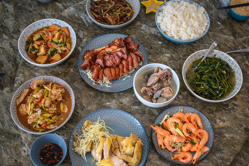 High angle view of Taiwanese food prepared for a family lunch and sitting on a dining room table ready for consumption.