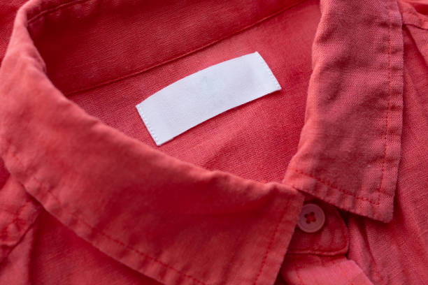 istock White blank clothing tag label on red linen shirt fabric texture background 1160865658