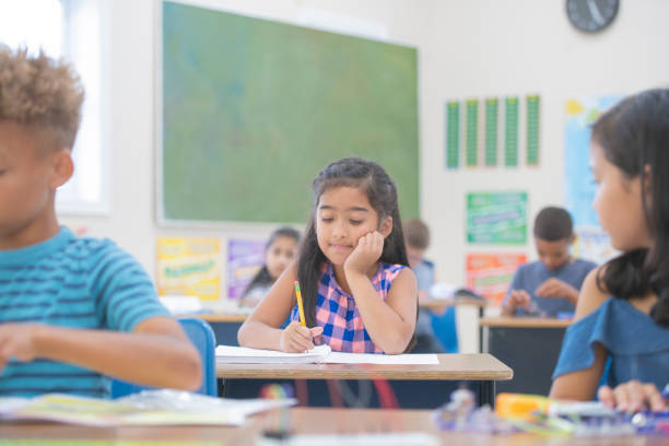 istock Indian Girl Working On School Work at Her Desk 1160867111