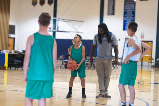 istock Coach talking with his elementary boy's basketball team 1160867139