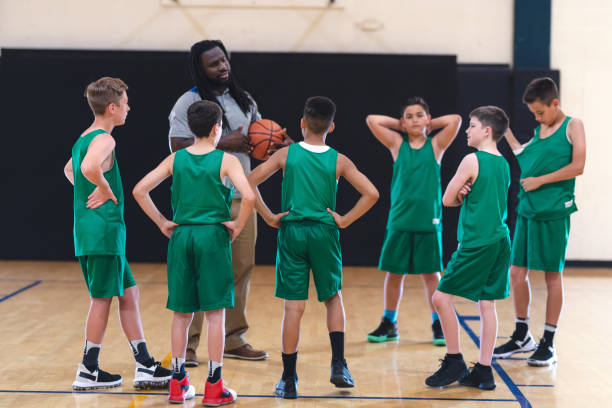 istock Coach talking with his elementary boy's basketball team 1160867140