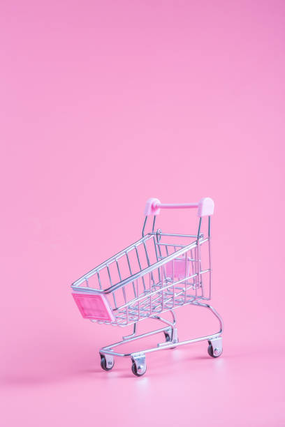 istock Shopping cart over pink background 1160874491