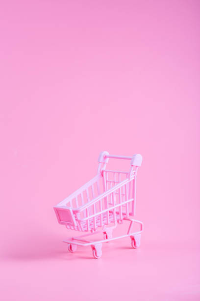 istock Shopping cart over pink background 1160874501