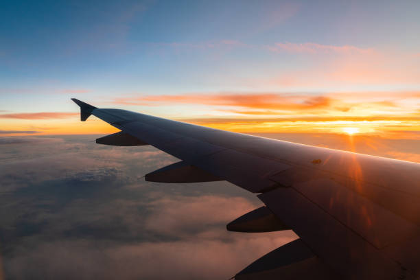 istock View from airplane window on the wing on sunrise/sunset time 1160878758