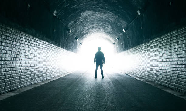 istock Young man in dark tunnel 1160883441