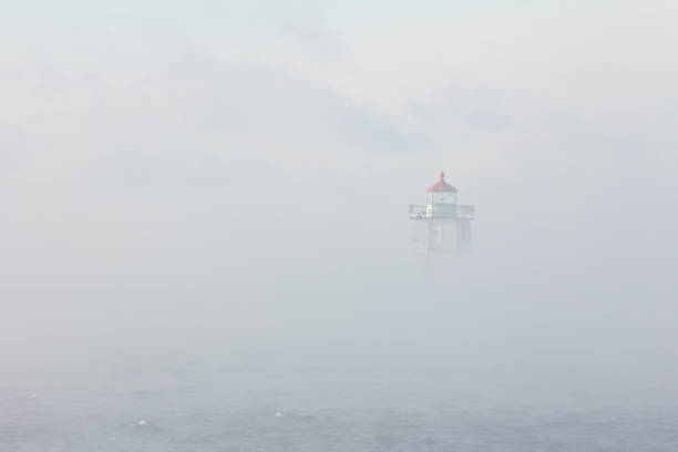 Lighthouse in the Fog stock photo