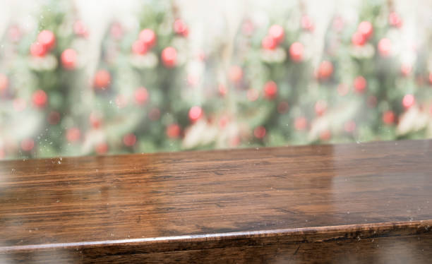 istock wooden table top with abstract blur christmas tree red decor ball and snow fall background with bokeh light,winter Holiday backdrop,Mock up banner for display of product or promotion. 1160886506