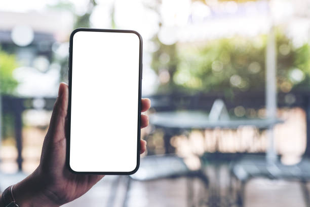 istock a woman's hand holding black mobile phone with blank desktop screen 1160887452