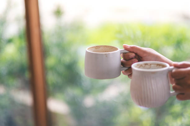 istock hands holding two white cups of hot coffee 1160887461