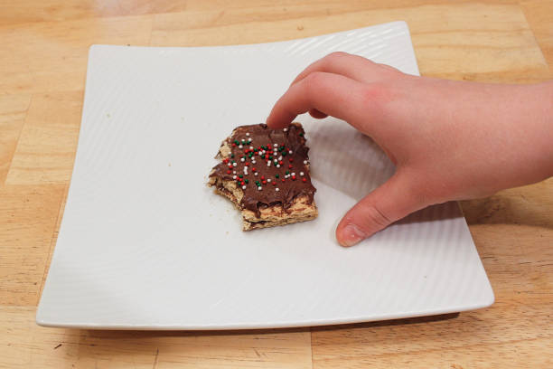 istock A childs hand grabing a treat off a white plate 1160888661