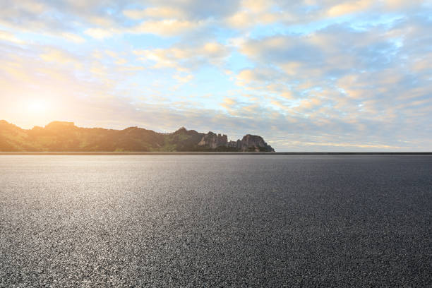 istock Asphalt road ground and mountain with clouds 1160889295