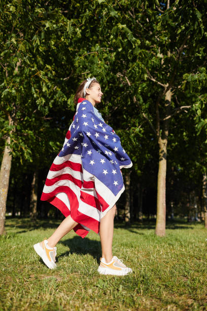 istock Girl wrapped in American flag 1160894346