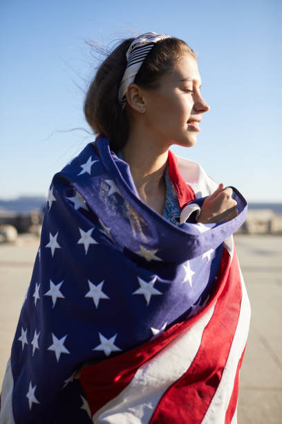 istock Enjoyable girl covered with American flag 1160894358