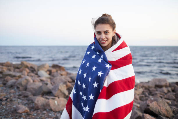 istock Positive woman strolling over rocky shore 1160894440