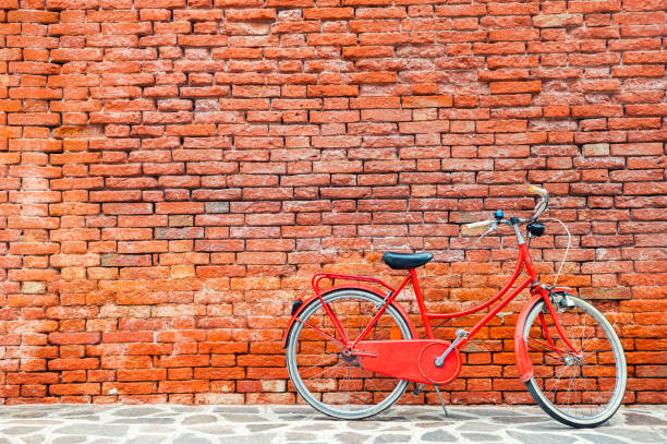 istock Red bicycle near the old red brick wall 1160896122