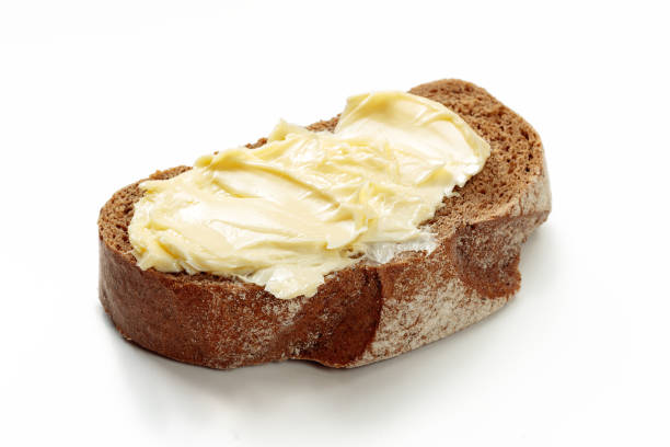 butter mit brot isoliert auf weißem hintergrund - butter margarine fat bread stock-fotos und bilder