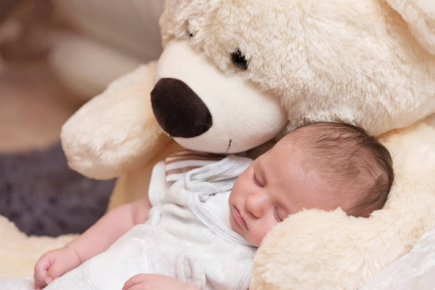 istock Baby Boy Sleeping with Big Teddy Bear 1160900538