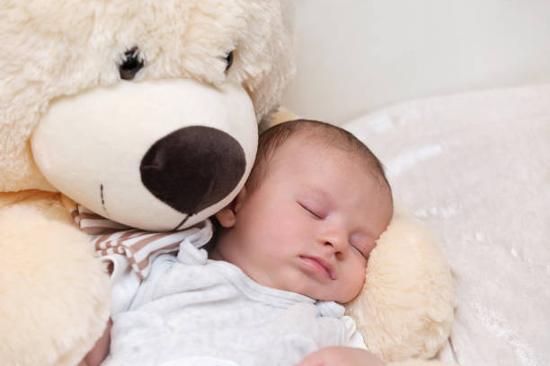 istock Baby Boy Sleeping with Big Teddy Bear 1160900539