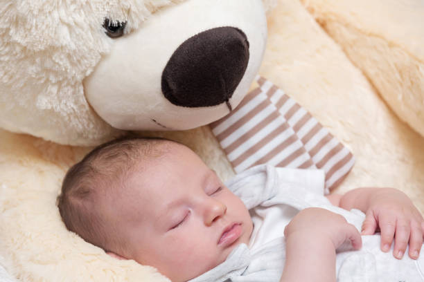 istock Baby Boy Sleeping with Big Teddy Bear 1160900541