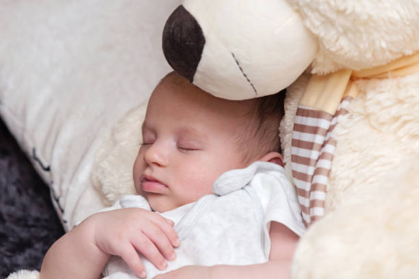istock Baby Boy Sleeping with Big Teddy Bear 1160900546