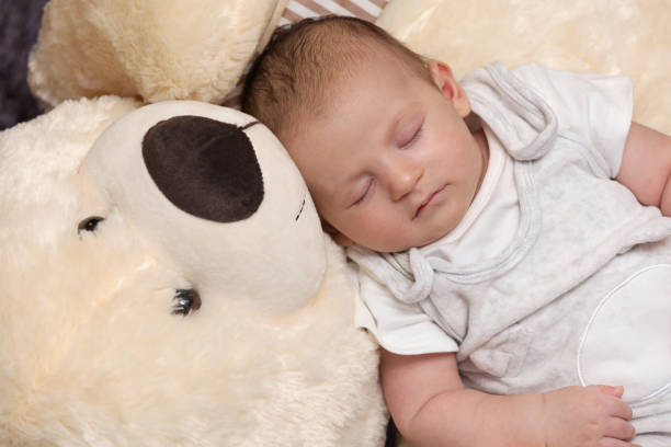 istock Baby Boy Sleeping with Big Teddy Bear 1160900552