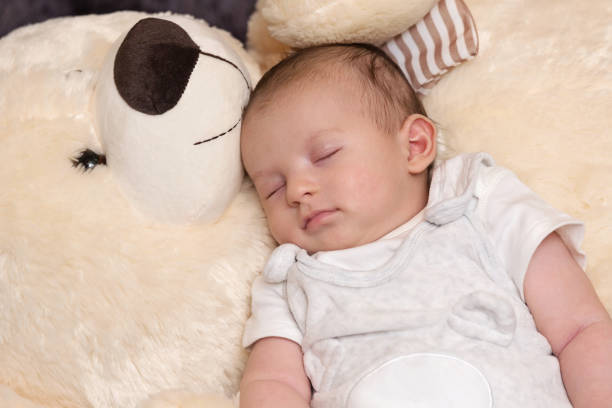 istock Baby Boy Sleeping with Big Teddy Bear 1160900557