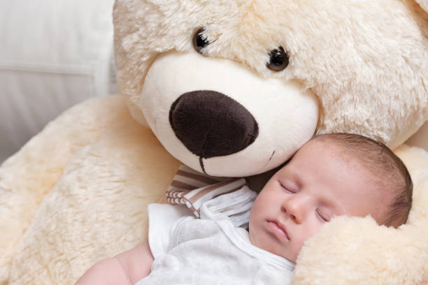 istock Baby Boy Sleeping with Big Teddy Bear 1160900592