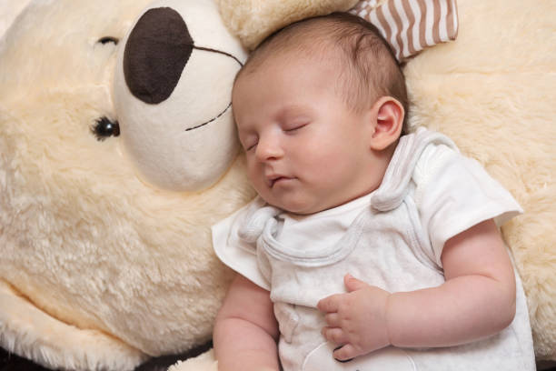 istock Baby Boy Sleeping with Big Teddy Bear 1160900593