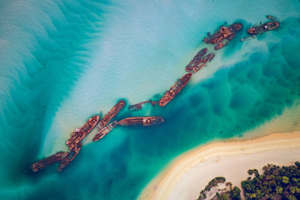 All Tangalooma Wrecks from above The Tangalooma Wrecks used to be 15 steam driven barges which were deliberately sunk in 1963 along the Moreton Island coastline to form a breakwall so that small boats can anchor in shelter brisbane photos stock pictures, royalty-free photos & images