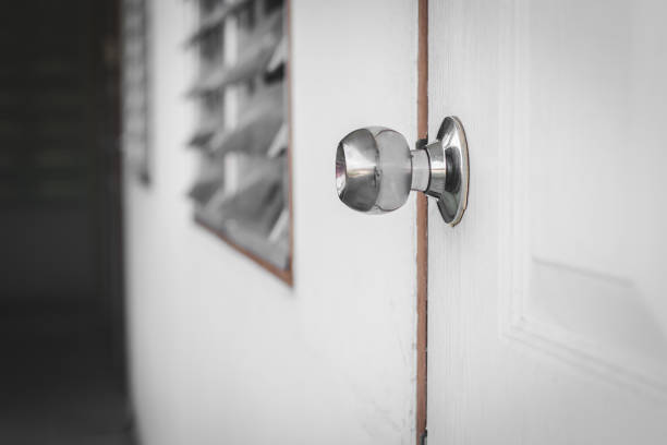 istock Door knob on white door with mysterious background 1160902039