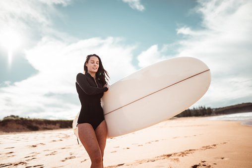 woman resting on the surf board in australia