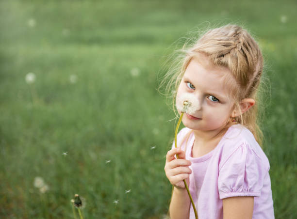 istock Little girl with dandelions 1160904169