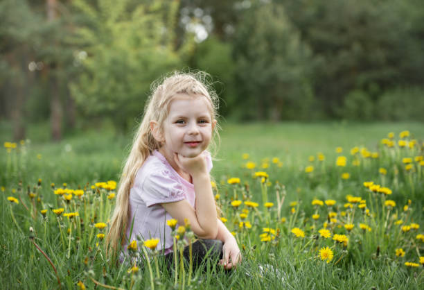 istock Little girl with dandelions 1160904173