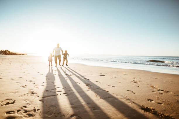 istock happiness father running on the beach with kids 1160905353