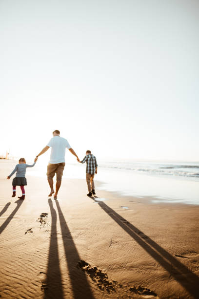 istock happiness father running on the beach with kids 1160905395