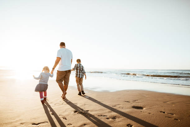 istock happiness father running on the beach with kids 1160905453