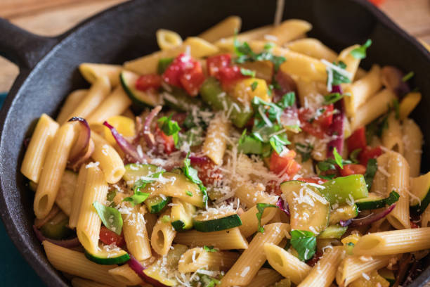 istock Penne pasta with vegetables and parmesan cheese 1160905705