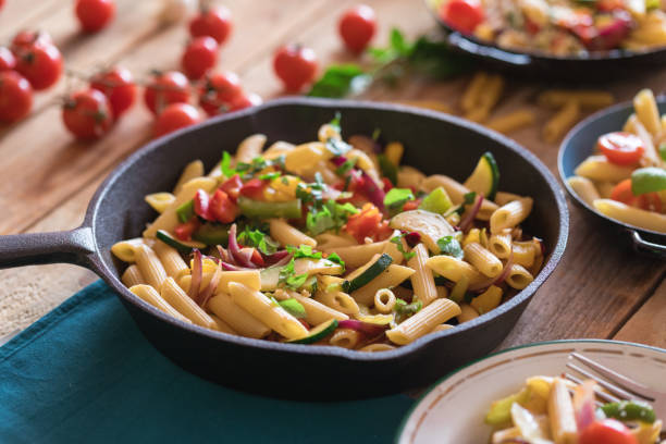 istock Penne pasta with vegetables and parmesan cheese 1160906307