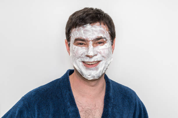 istock Funny man with natural white cream mask on his face 1160907711