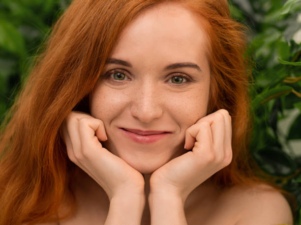 istock Curious redhead woman pillowing face on her hands 1160908824