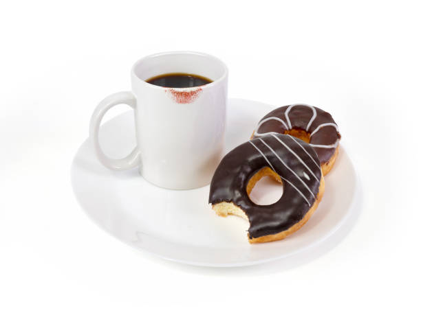 istock coffee in White mug and chocolate donuts on a white plate on the white background, Cup of coffee with lipstick mark 1160911153