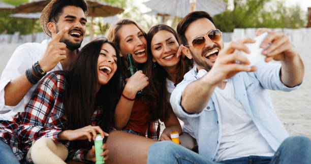 istock Group of young friends laughing and drinking beer 1160912541