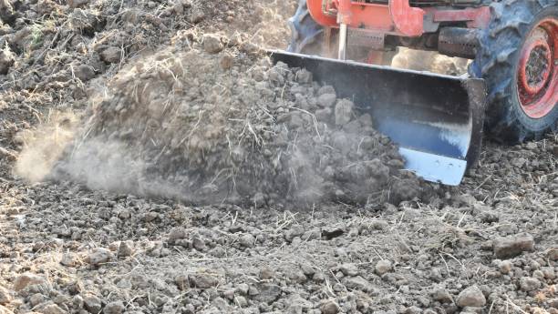 istock tractor push clot soil after pour from truck 1160912712