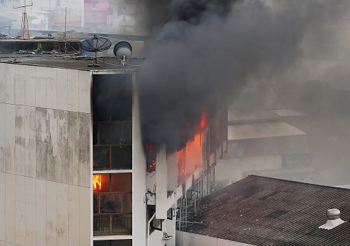 flames and smoke rise from burning building