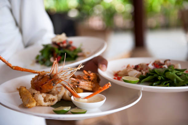 istock Waiter serving plates with food 1160913965