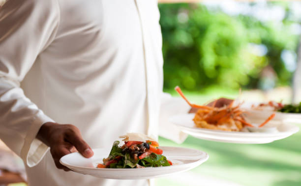 istock Waiter bringing two plates with food to the table 1160914441