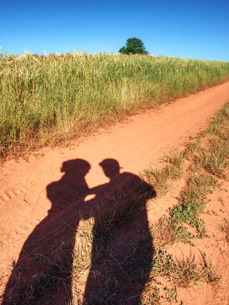istock People shadows on old dusty road with ferric red soil.  Shadows 1160915457