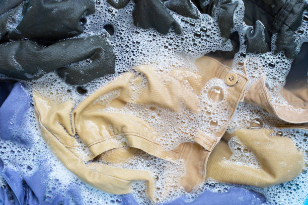 istock Trousers soak in powder detergent water dissolution. Laundry concept 1160917876
