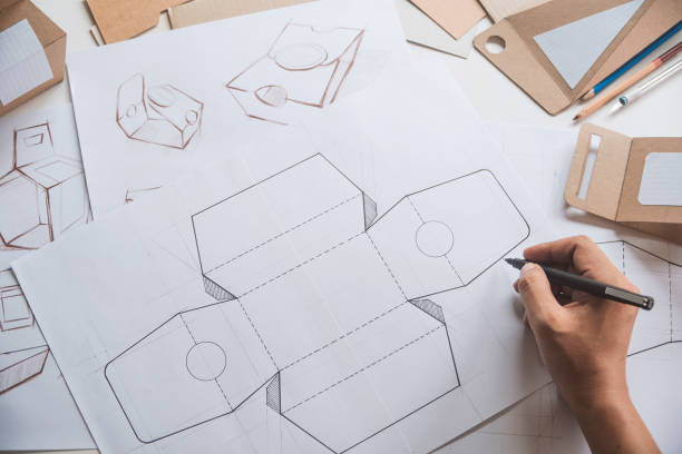istock Designer sketching drawing design Brown craft cardboard paper product eco packaging mockup box development template package branding Label . designer studio concept . 1160919009