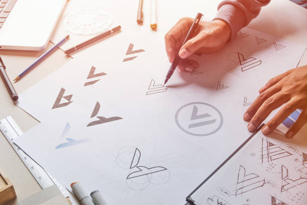 istock Graphic designer drawing sketch design creative Ideas draft Logo product trademark label brand artwork. Graphic designer studio Concept. 1160919024